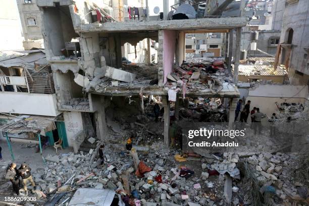 An aerial view of the residents search for their belongings among the rubble of almost completely collapsed buildings after Israeli attack on...