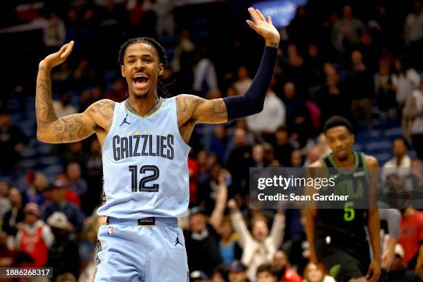 Ja Morant of the Memphis Grizzlies reacts after a dunk during overtime of an NBA game against the New Orleans Pelicans at Smoothie King Center on...