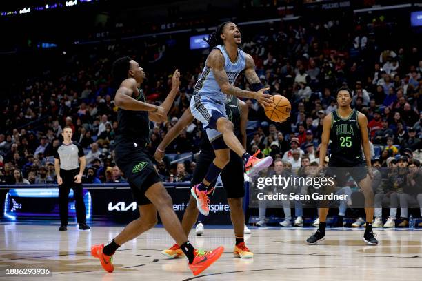 Ja Morant of the Memphis Grizzlies shoots over Herbert Jones of the New Orleans Pelicans during fourth quarter of an NBA game at Smoothie King Center...