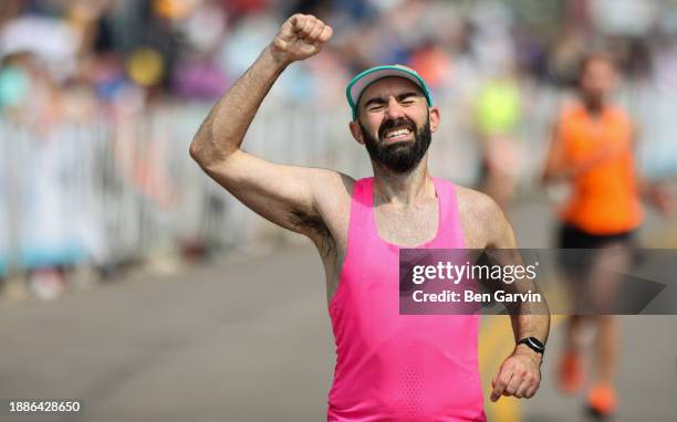 powerful marathon finish line celebration moment - exhausted at finish line stock pictures, royalty-free photos & images