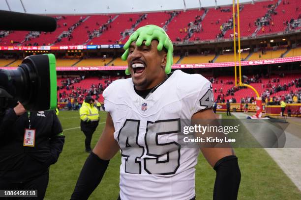 Las Vegas Raiders fullback Jakob Johnson wears a Nickelodeon slime head hat during an NFL football game against the Kansas City Chiefs on December...