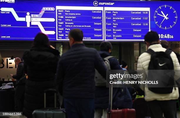 Eurostar arrivals and departures are seen cancelled and delayed on an information board at St Pancras station in London on December 30 as services...