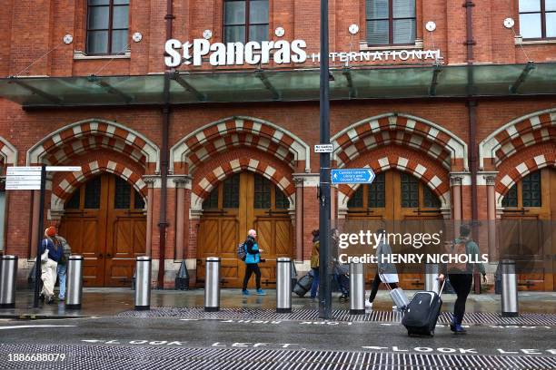 Passengers arrive at St Pancras International where Eurostar departures have been disrupted due to flooding in London on December 30, 2023. Eurostar...