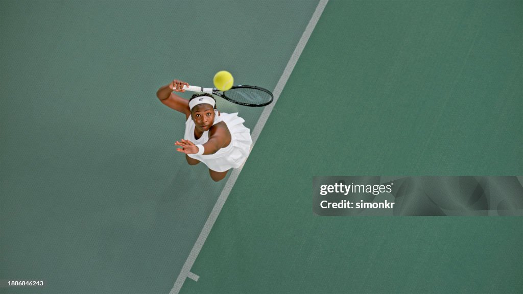 Tennis player playing in tennis court