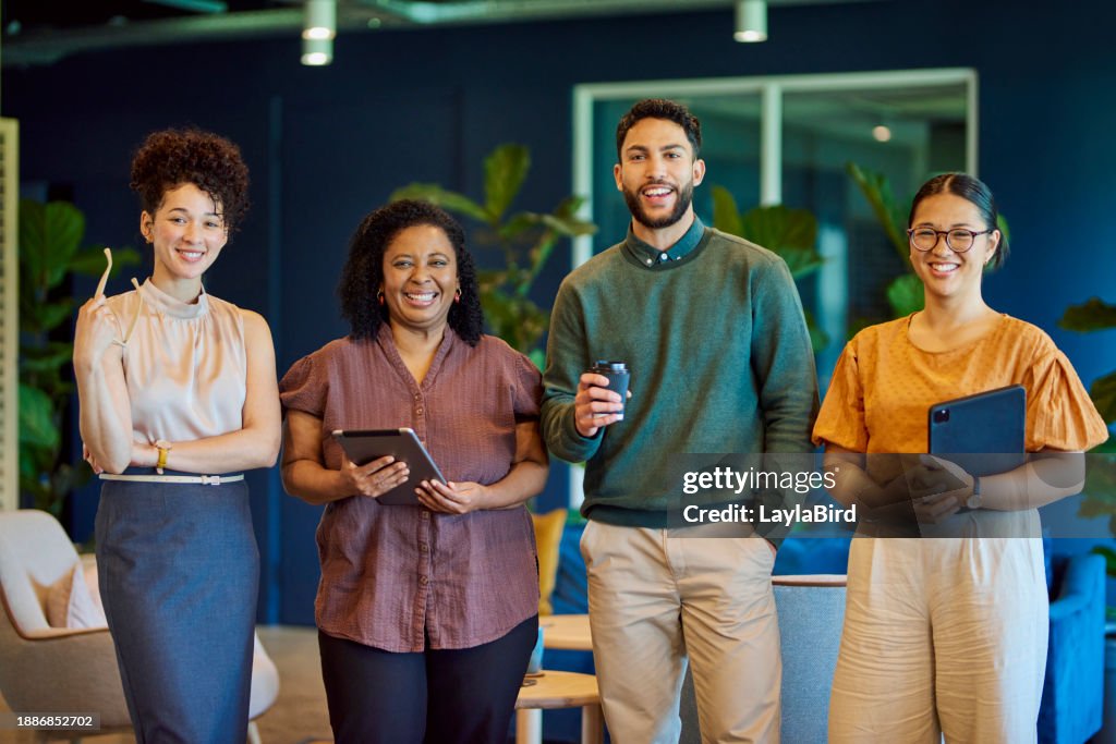 Portrait of confident business people smiling cheerfully at camera in office breakout space