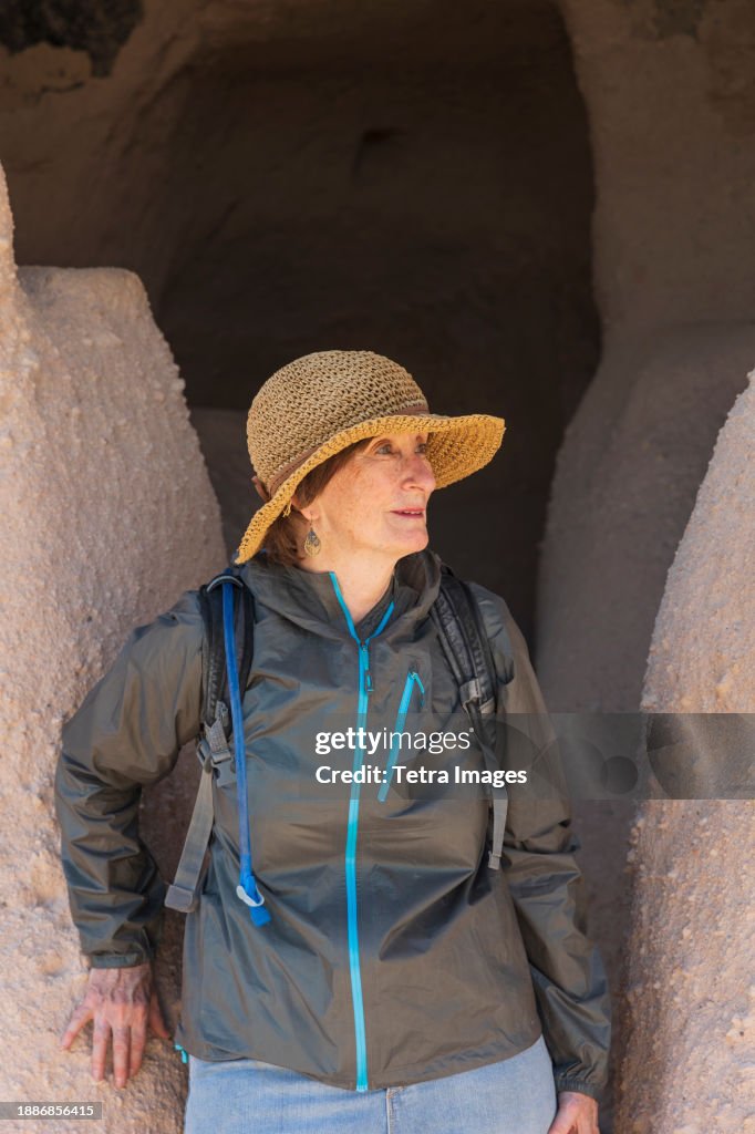 Woman in straw hat at Puye Cliff Dwelling