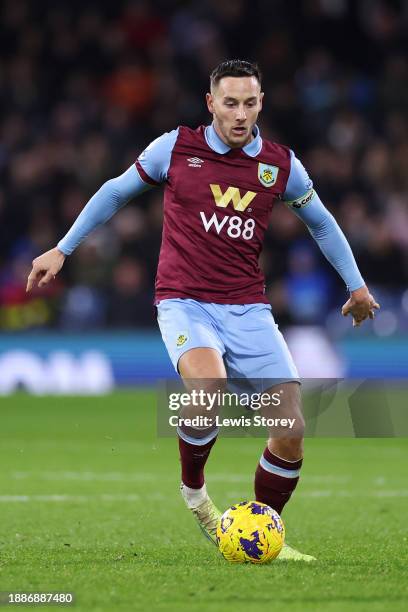 Josh Brownhill of Burnley runs with the ball during the Premier League match between Burnley FC and Liverpool FC at Turf Moor on December 26, 2023 in...