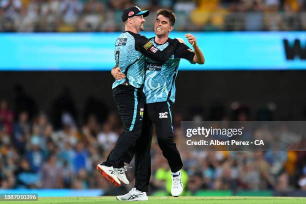 Colin Munro and Xavier Bartlett of the Heat celebrate victory during the BBL match between Brisbane Heat and Sydney Thunder at The Gabba, on December...