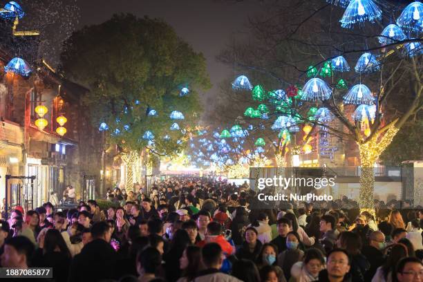 Tourists are viewing lanterns at the Laomendong scenic spot in Nanjing, China, on December 30, 2023.