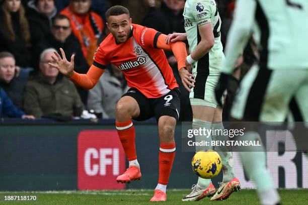 Luton Town's English striker Carlton Morris takes a quick freekick during the English Premier League football match between Luton Town and Chelsea at...