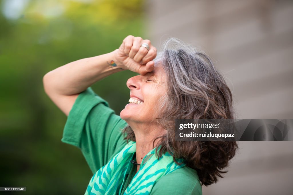 Portraits of a beautiful 59-year-old woman, natural, full, happy, lesbian, proud of herself and authentic