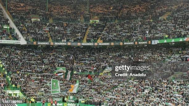 Fans of Celtic FC wave Palestinian flag to show solidarity with Palestinians during the Scottish Premiership 'Old Firm' derby football match between...
