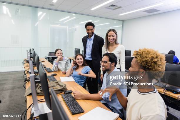 male professor and fellow students listen to young man - asian-students-classroom-computer stock pictures, royalty-free photos & images