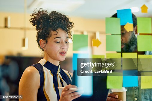 Two business professionals discussing ideas in an office. Two business professionals discussing ideas in an office.