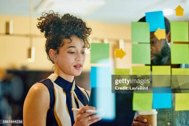 two business professionals discussing ideas in an office. - best execution stock pictures, royalty-free photos & images