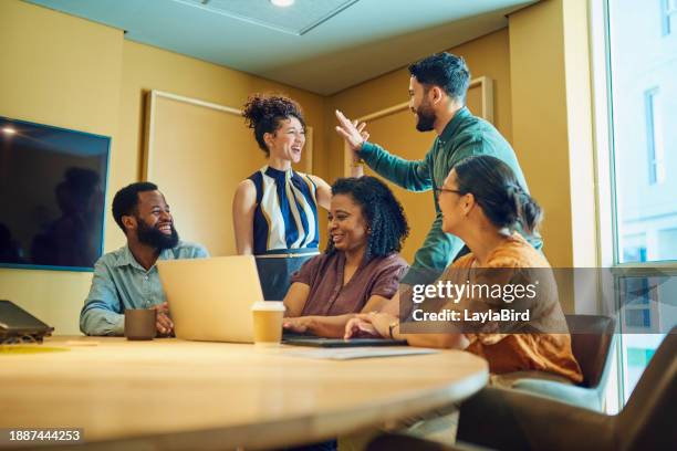 diverse group of business professionals collaborating on a project using laptop in a modern office space. - best execution stock pictures, royalty-free photos & images