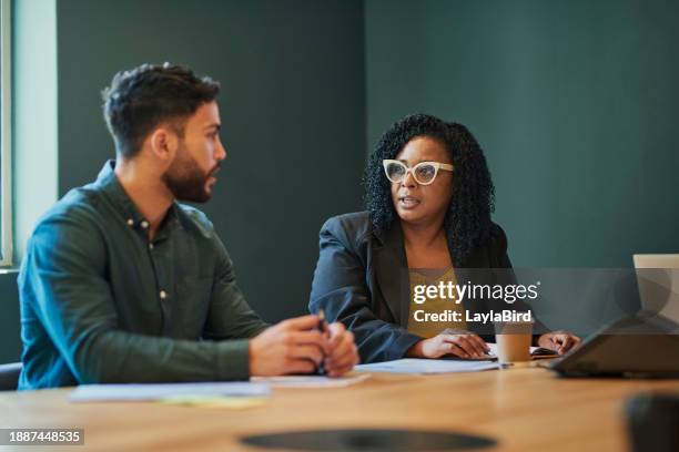 two business professionals having a meeting in an office discussing ideas and strategies - workplace respect stock pictures, royalty-free photos & images