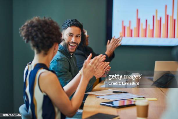 group of business professionals clapping and smiling during a meeting in the boardroom. - positive emotion stock pictures, royalty-free photos & images