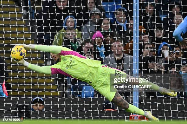 Manchester City's Brazilian goalkeeper Ederson makes a save during the English Premier League football match between Manchester City and Sheffield...