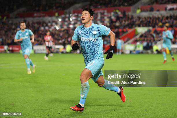 Hwang Hee-Chan of Wolverhampton Wanderers celebrates after scoring their sides second goal during the Premier League match between Brentford FC and...