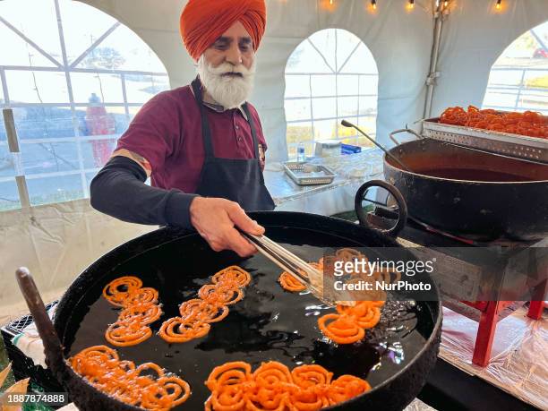 Man is preparing jalebis, a traditional Indian sweet, during the festival of Diwali at a sweetshop in Mississauga, Ontario, Canada, on November 12,...