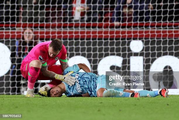 Hwang Hee-Chan of Wolverhampton Wanderers is seen injured while being consoled by Mark Flekken of Brentford prior to being substituted off during the...