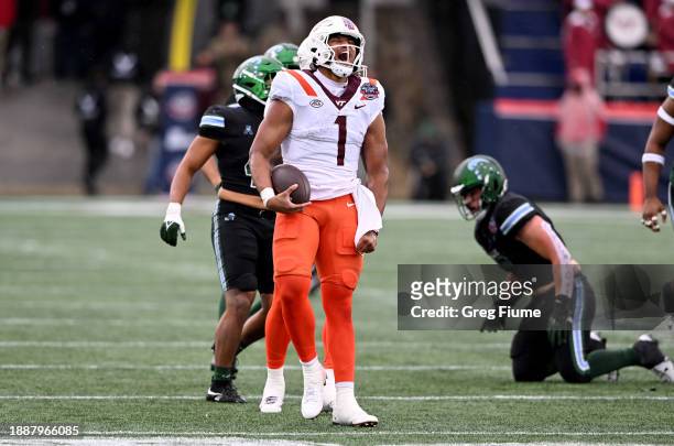 Kyron Drones of the Virginia Tech Hokies celebrates after a first down in the first quarter against the Tulane Green Wave during the Military Bowl...