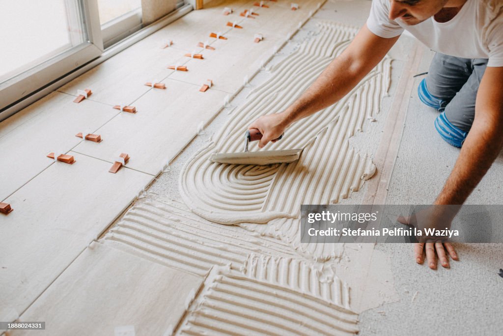 Construction Worker Spreading The Thin-set