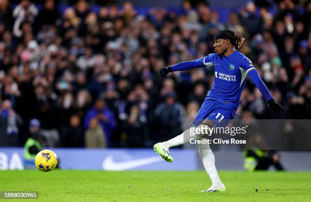 Noni Madueke of Chelsea scores their team's second goal from the penalty spot during the Premier League match between Chelsea FC and Crystal Palace...