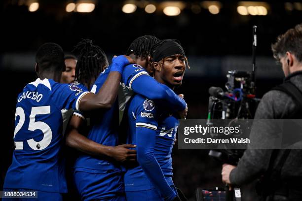 Noni Madueke of Chelsea celebrates with teammates after scoring their team's second goal from the penalty-spot during the Premier League match...