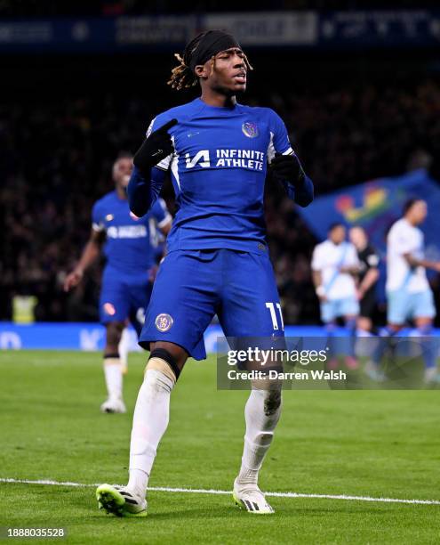Noni Madueke of Chelsea celebrates after scoring their team's second goal from the penalty-spot during the Premier League match between Chelsea FC...