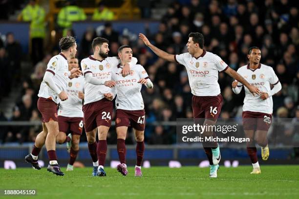 Phil Foden of Manchester City celebrates with team mates after scoring their sides first goal during the Premier League match between Everton FC and...