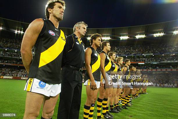 Wayne Campbell for the Tigers and coach Danny Frawley lineup during the national anthem before the round one AFL match between the Collingwood...