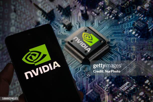 The NVIDIA logo is being displayed on a smart phone, with an NVIDIA chip visible in the background, in this photo illustration taken in Brussels,...