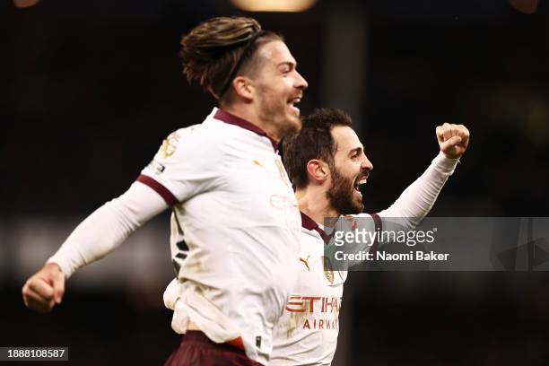 Bernardo Silva of Manchester City celebrates with Jack Grealish of Manchester City after scoring their sides third goal during the Premier League...