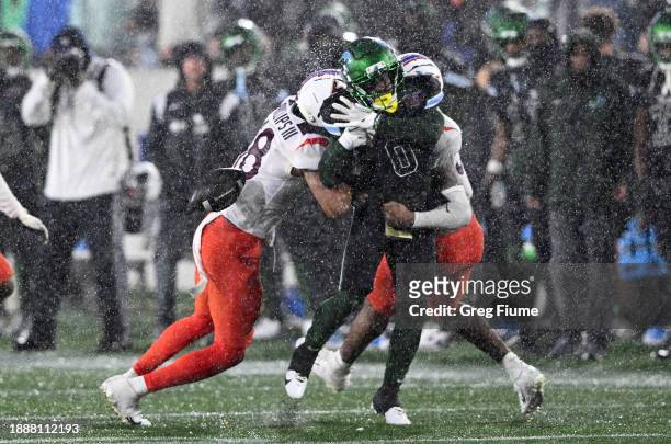 Shedro Louis of the Tulane Green Wave fumbles the ball in the fourth quarter against Mose Phillips III of the Virginia Tech Hokies during the...