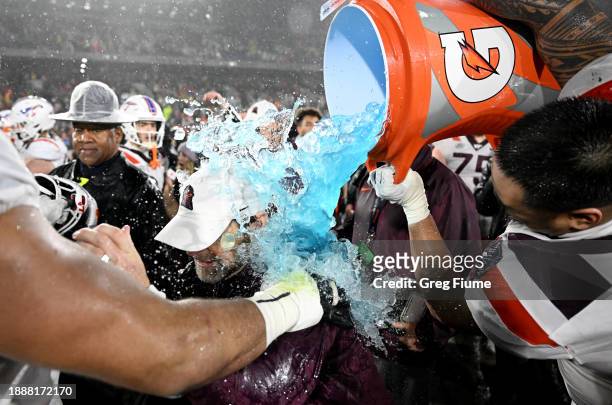 Head coach Brent Pry of the Virginia Tech Hokies is doused with Gatorade after a 41-20 victory against the Tulane Green Wave during the Military Bowl...