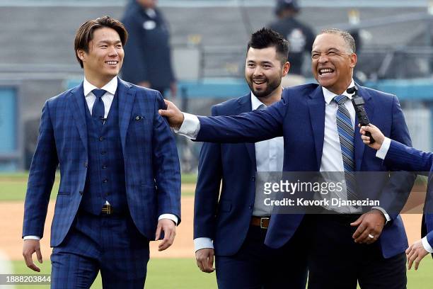 Yoshinobu Yamamoto speaks with Manager Dave Roberts prior to an introductory press conference at Dodger Stadium on December 27, 2023 in Los Angeles,...