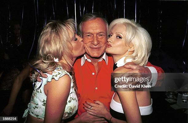 Playboy publisher Hugh Hefner gets kisses from Playboy playmates Bridget and Holly Madison at Hefner's 77th birthday party at Barfly March 30, 2003...