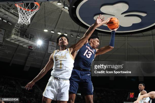 Virginia Cavaliers guard Ryan Dunn grabs a rebound against Notre Dame Fighting Irish guard Julian Roper II on December 30 at the Purcell Pavilion at...