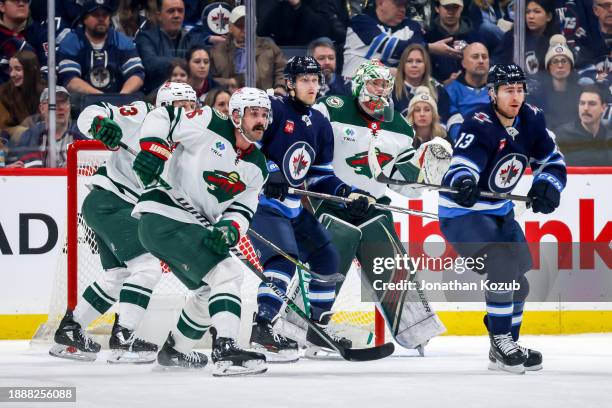 Nikolaj Ehlers and Gabriel Vilardi of the Winnipeg Jets battle Marco Rossi, Jake Middleton and goaltender Filip Gustavsson of the Minnesota Wild as...