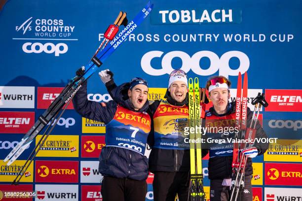 Second placed Jules Chappaz of France, first placed Lucas Chanavat of France and third Ben Ogden of the United States celebrates at the award...