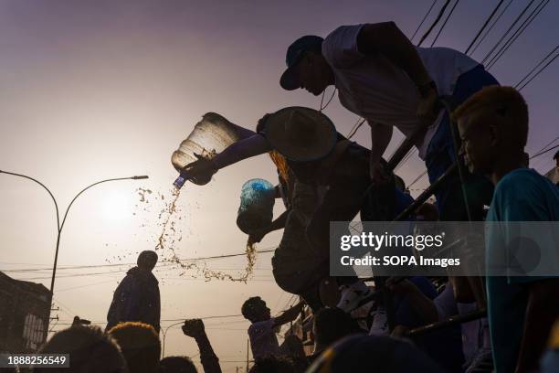 People are seen throwing rum at the statue of San Benito during the procession. The San Benito festival is celebrated in Cabimas within the Zulia...