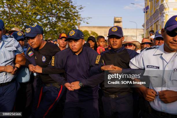 Police officers are seen in the crowd during the procession. The San Benito festival is celebrated in Cabimas within the Zulia state every December...