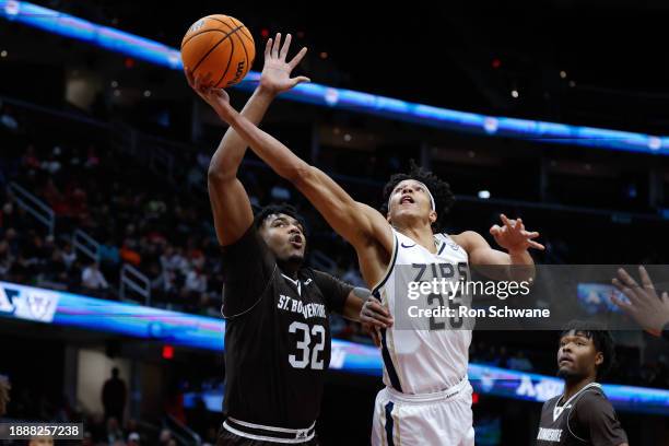 Enrique Freeman of the Akron Zips shoots against Chad Venning of the St. Bonaventure Bonnies in the first half during the Legends of Basketball...