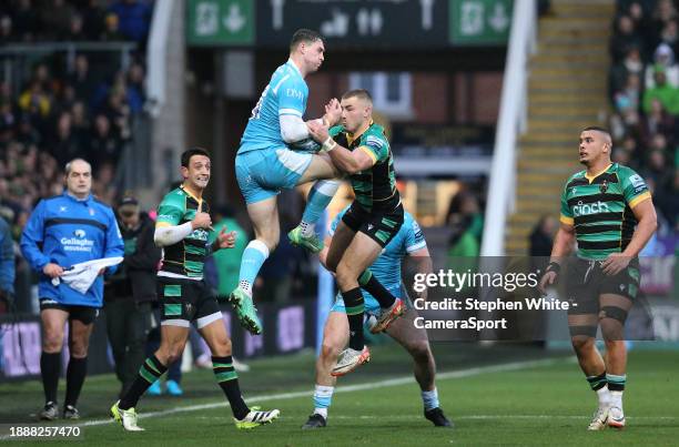 Sale Sharks's Tom Roebuck fumbles a catch under pressure from Northampton Saints's Ollie Sleightholme during the Gallagher Premiership Rugby match...