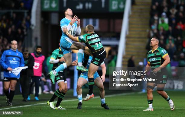 Sale Sharks's Tom Roebuck fumbles a catch under pressure from Northampton Saints's Ollie Sleightholme during the Gallagher Premiership Rugby match...