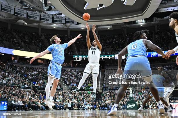 Michigan State Spartans guard A.J. Hoggard releases a step-back jumper over Indiana State Sycamores guard Jake Wolfe during a college basketball game...