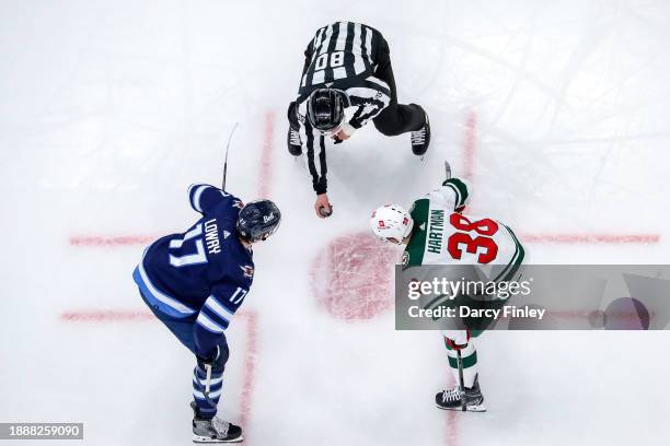 Adam Lowry of the Winnipeg Jets gets set to take a third period face-off against Ryan Hartman of the Minnesota Wild at the Canada Life Centre on...