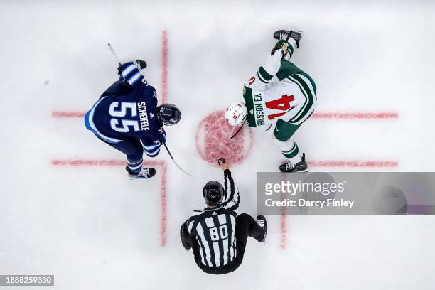 Mark Scheifele of the Winnipeg Jets gets set for a third period face-off against Joel Eriksson Ek of the Minnesota Wild at the Canada Life Centre on...